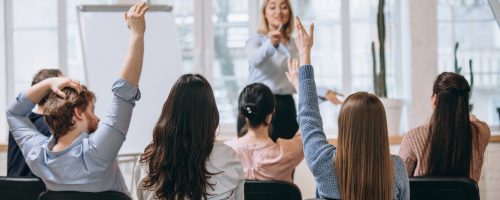 female-speaker-giving-presentation-in-hall-at-university-workshop-audience-or-conference-hall